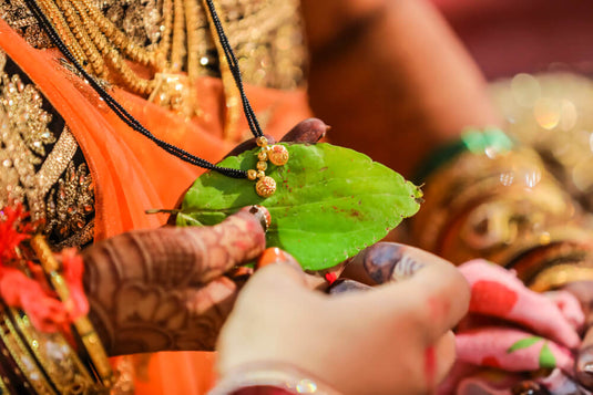 A culturally significant mangalsutra being tied to the bride by groom during a hindu marriage ritual. 