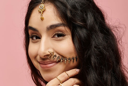 A perfect gold nose pin styled by an Indian woman. With the right size and the right placement of the nose pin. 