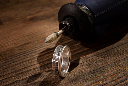 A silver ring for men that is perfect for gifting on birthday being crafted by the jeweler. 